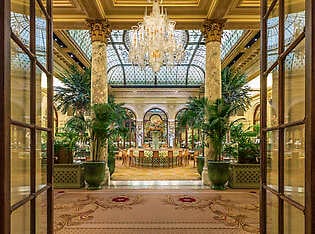 The view of the Palm Court at The Plaza Hotel through the entrance of the glass doors.