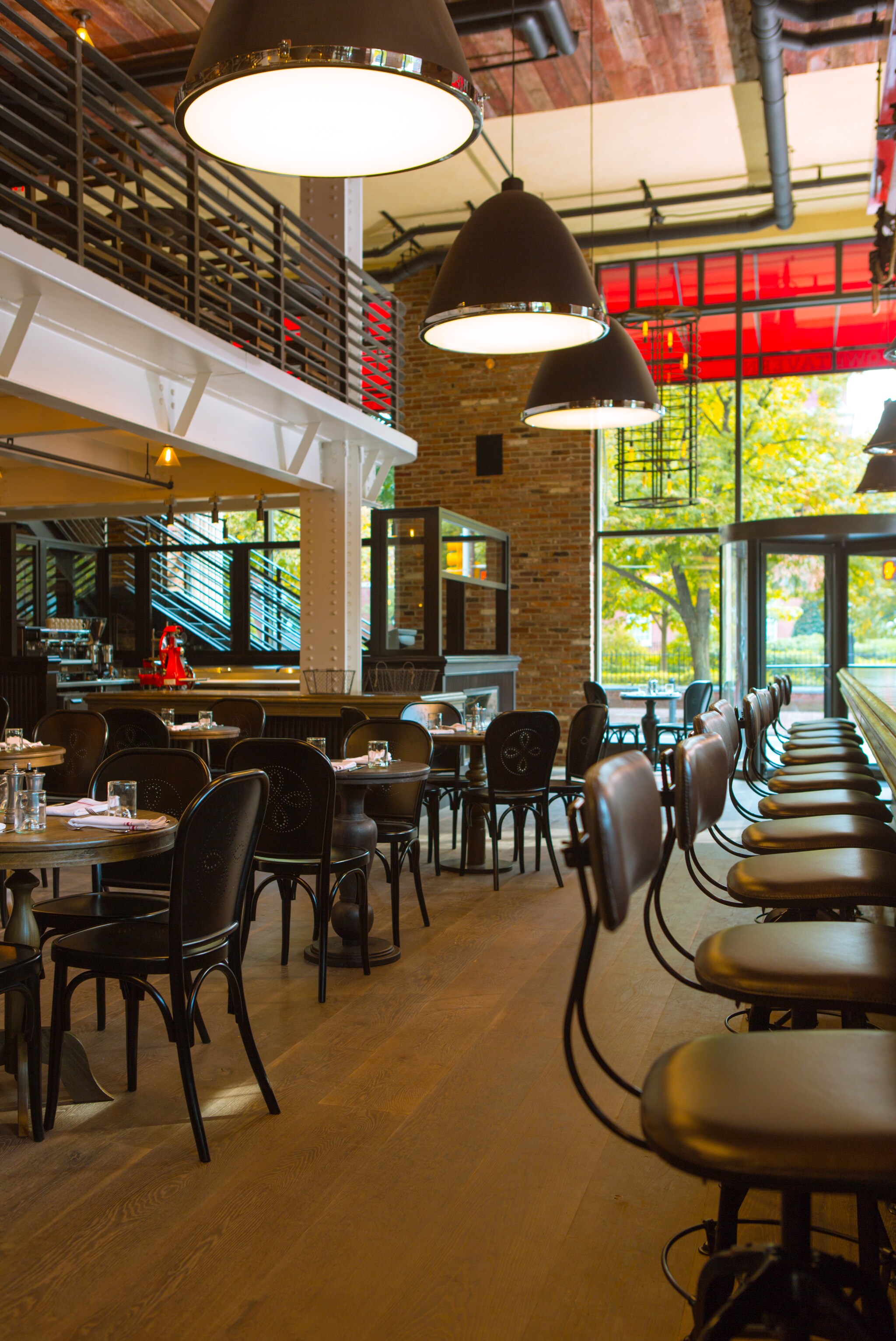 The Red Owl Tavern Restaurant is industrial chic, with high ceilings, exposed brick walls, a lofted balcony, and a long bar.