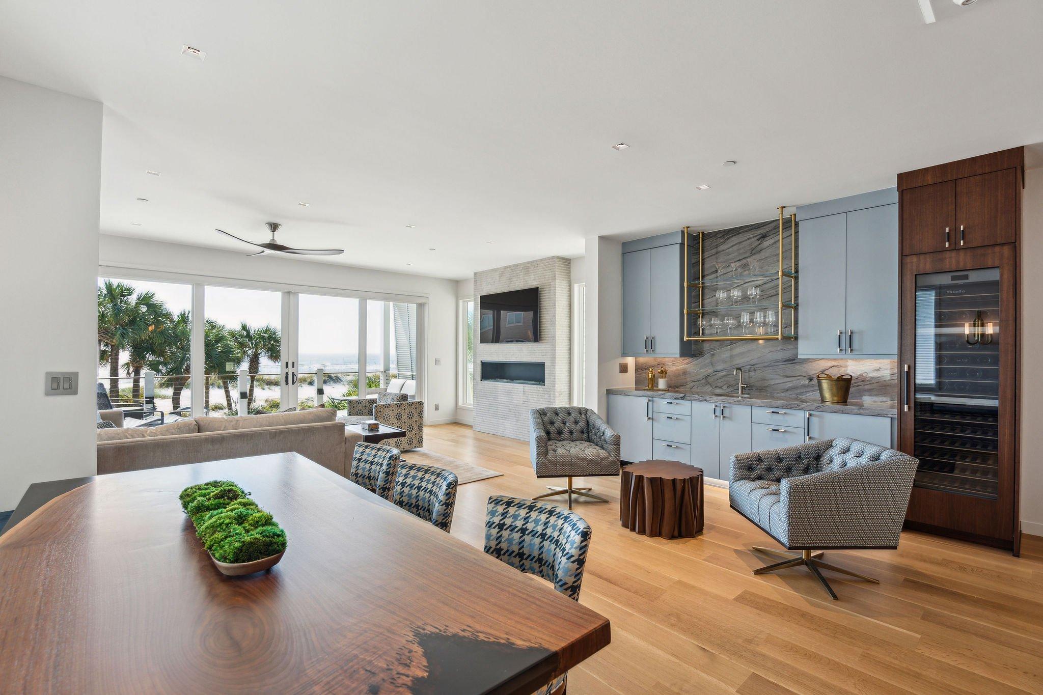 Interior of living and dining areas of beach house with view of the ocean.