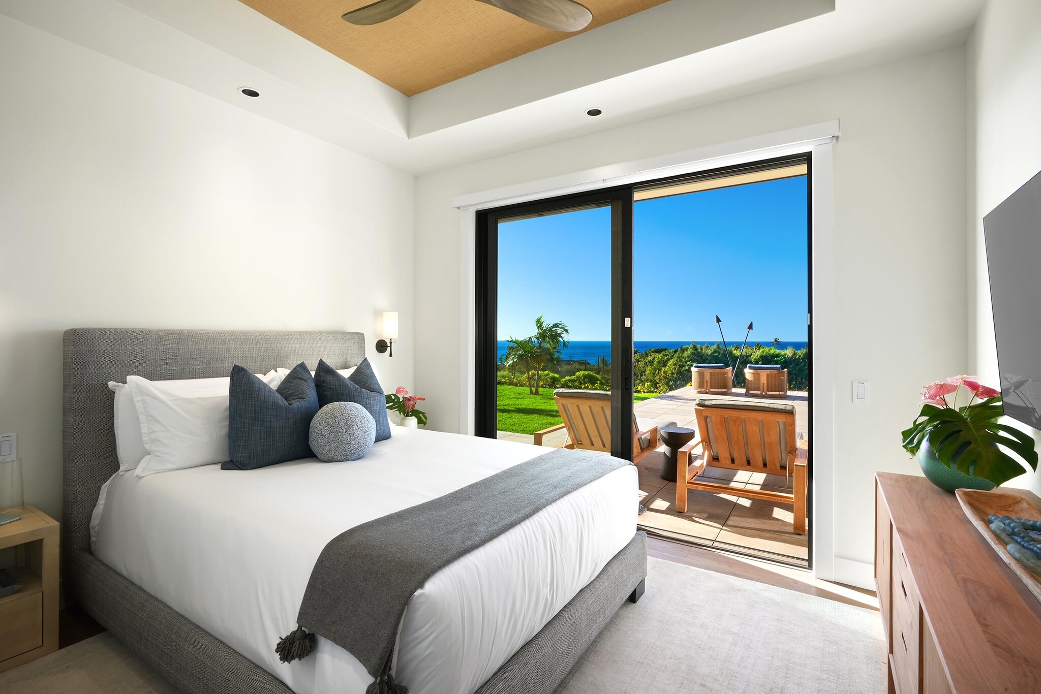 Bedroom interior with sliding glass door leading to outdoor patio.