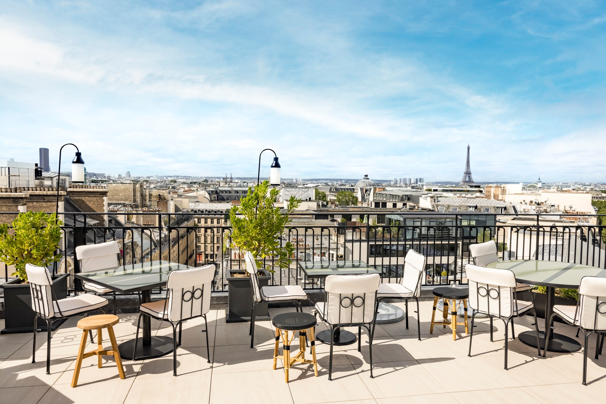 From the rooftop bar, Sequoia, small tables with chairs are stationed by cast-iron railing to look over the city and the Eiffel Tower.