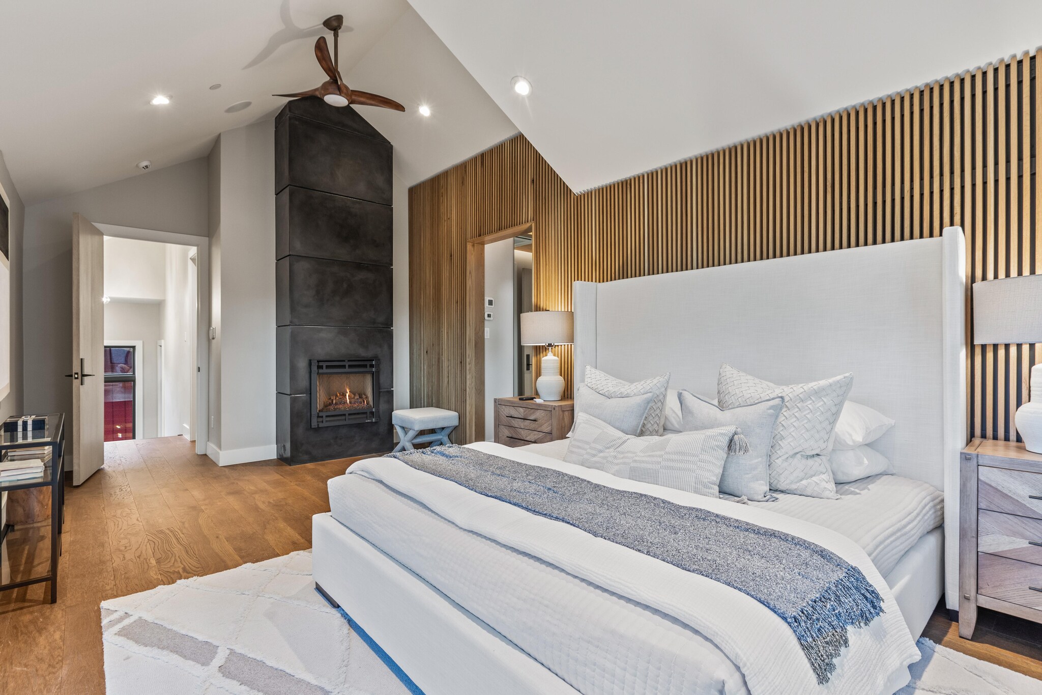 Interior of rustic bedroom with fireplace.