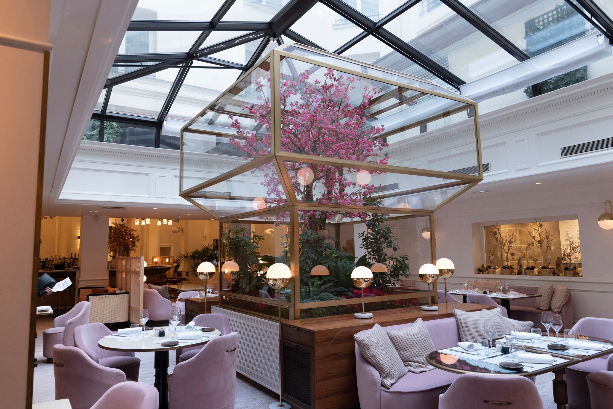 In Rivages, the hotel’s Mediterranean restaurant, pale pink furnishings are complemented by a pink flowering tree in a glass terrarium.