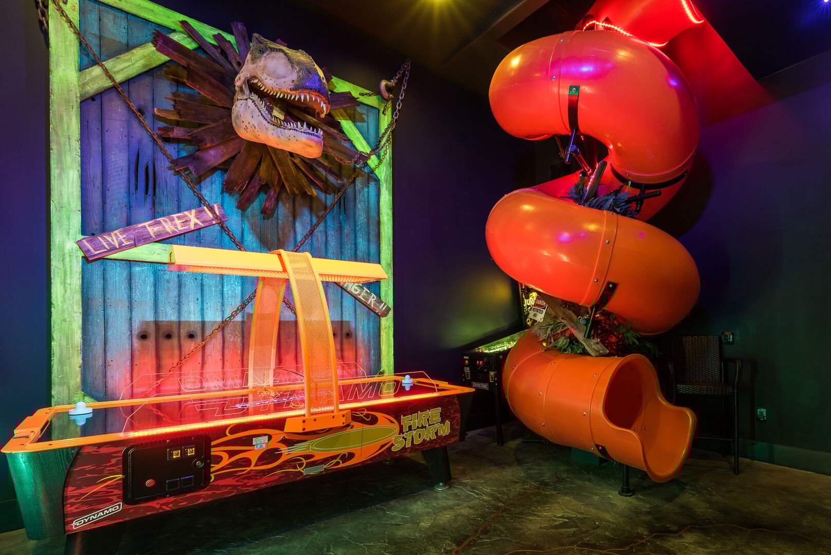 Interior of recreation room with air hockey and two-story tube slide.