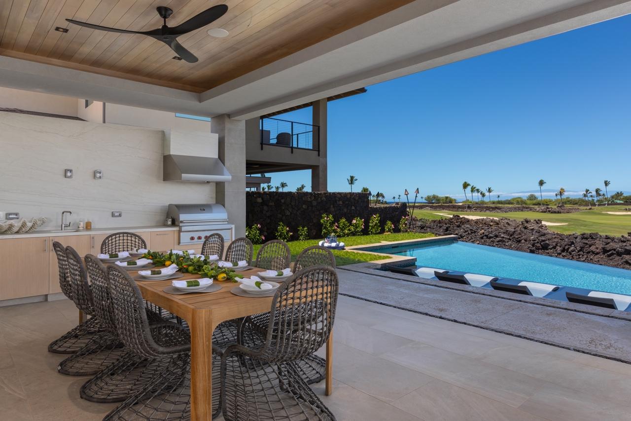 Outdoor patio and BBQ area with view of swimming pool and golf course.