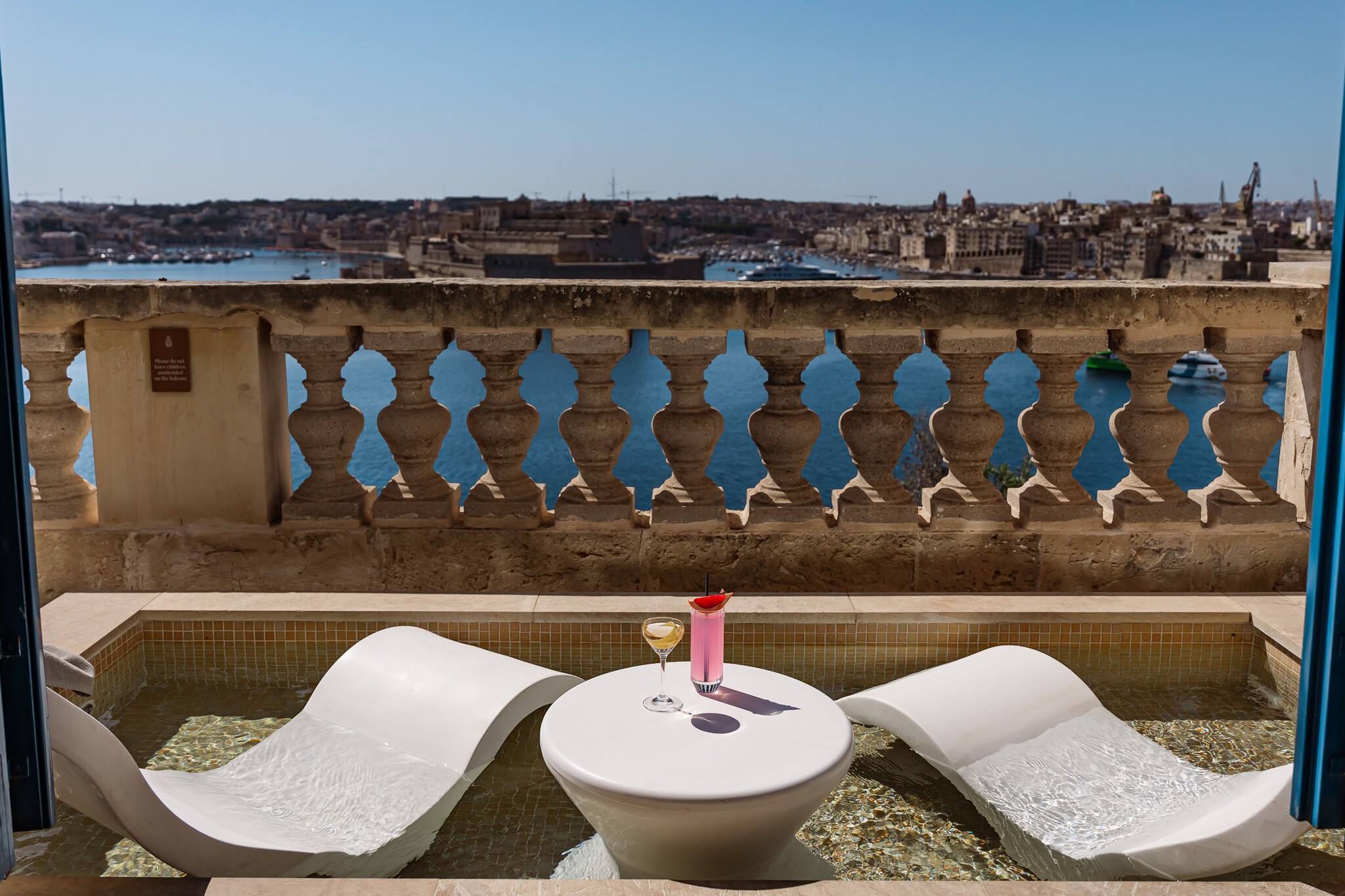  The Presidential Penthouse Terrace includes a small pool with two curved seats half-submerged for a cool place to sit in view of the harbor.