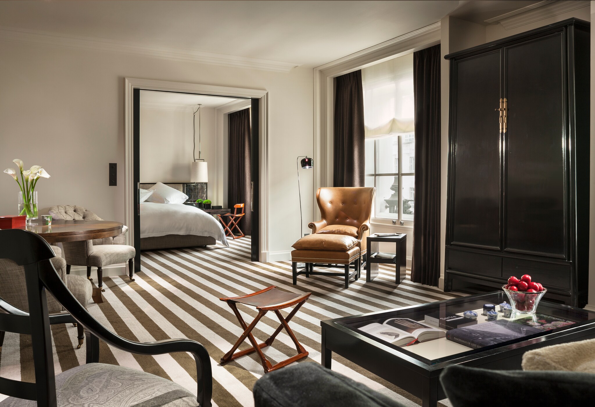 The Premier Suite sports black-and-white striped floors. Through a large living area with several seating nooks lies a separate bedroom.