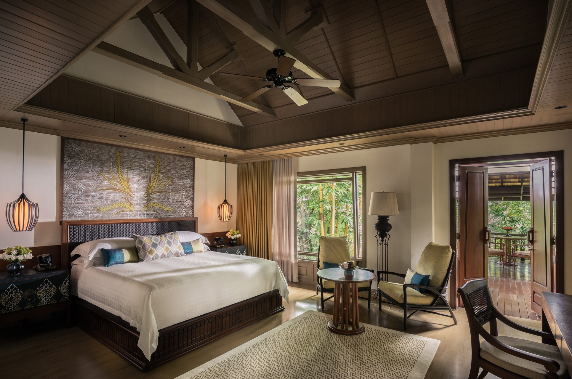 In a Lower Rice Terrace guest room, greenery outside the window is echoed in a botanical hanging over the bed.