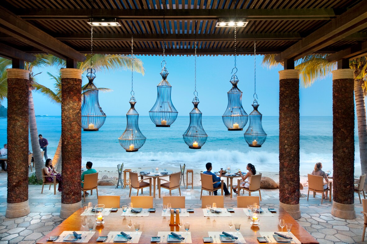 FRESH Restaurant opens right onto the beach. Candles hang in metal cages from the ceiling and stone pillars frame diners at small tables.