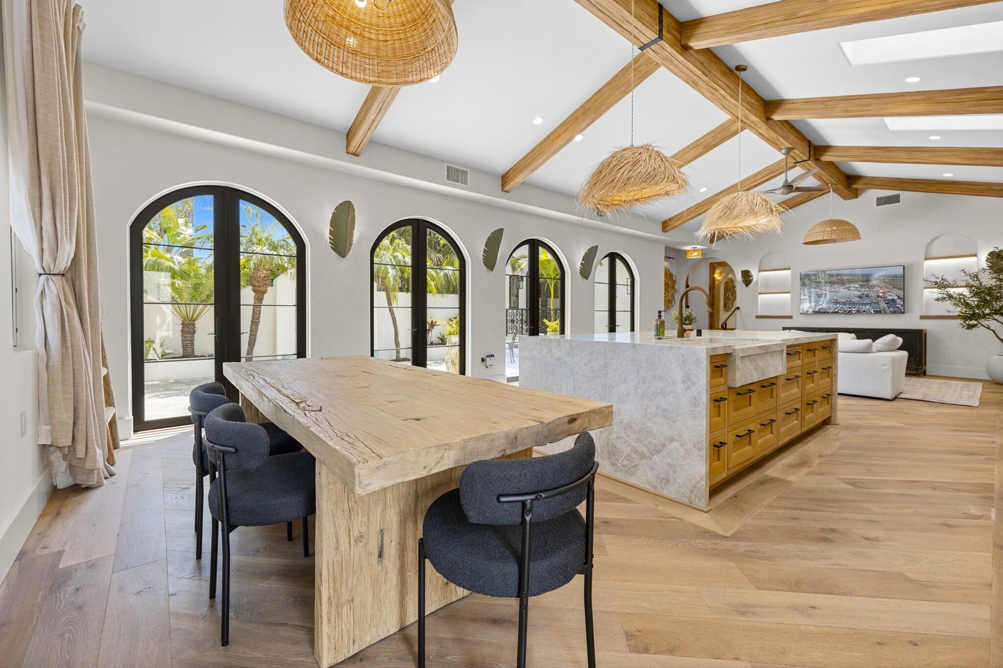 Bright interior of Spanish-style bungalow showcasing kitchen, dining, and living areas