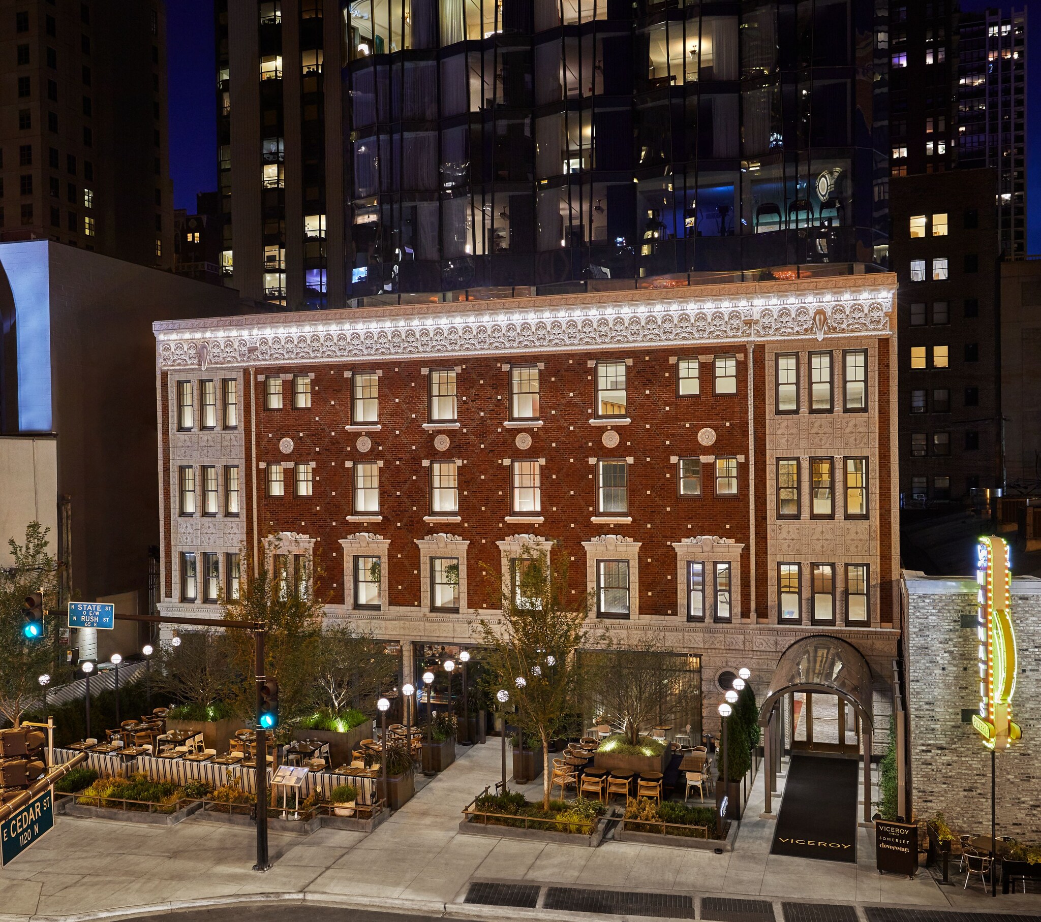 Exterior of Viceroy Chicago. A courtyard and a 1920s brick-and-stone façade are backed by a new 18-story steel-and-glass building.