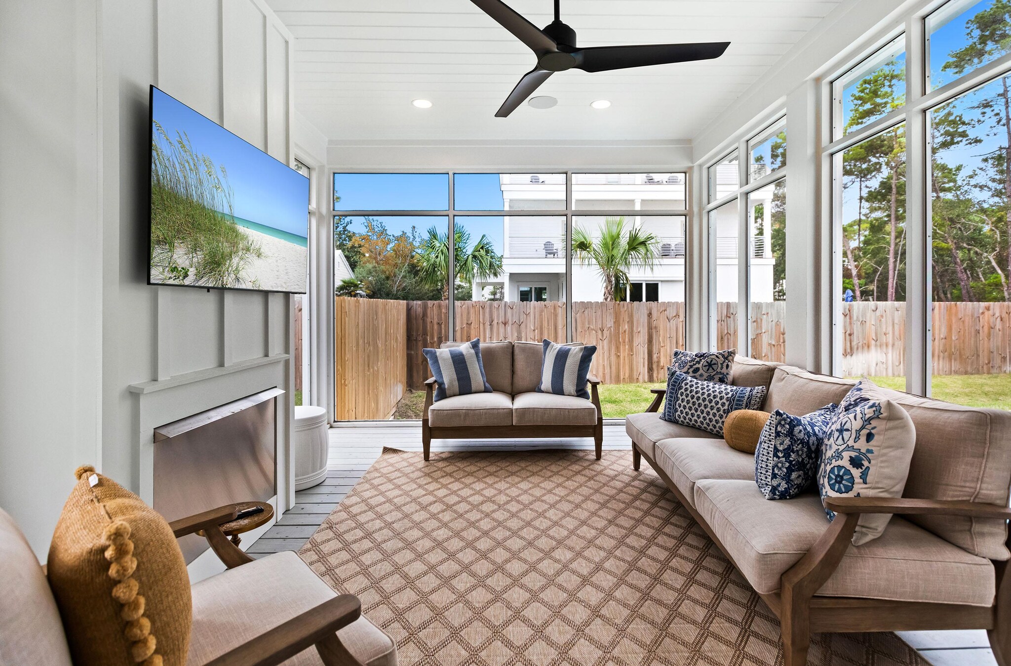 Screened in porch with seating and fireplace.