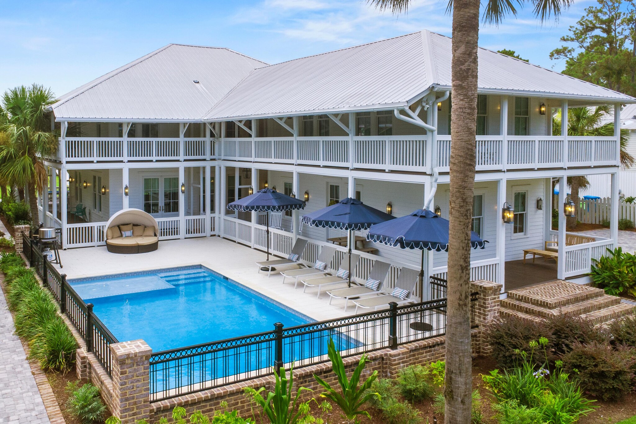 Two-story home with wrap-around second story deck overlooking the swimming pool.