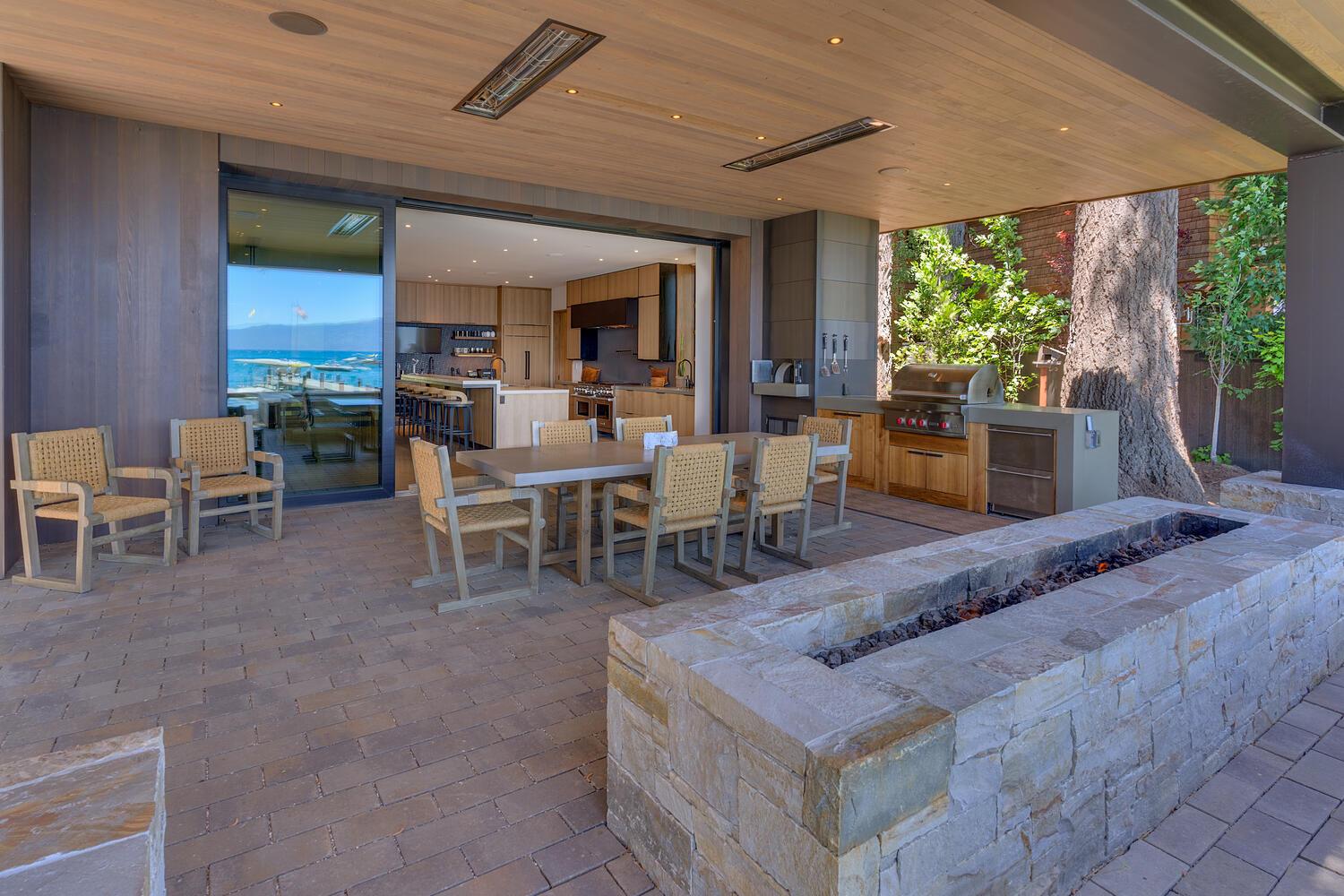 Outdoor patio seating and dining area with firepit.