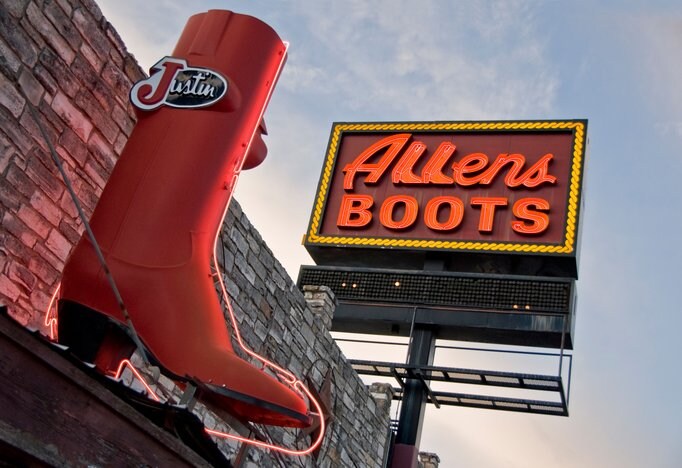 The Allen’s Boots sign features neon rope around the edges, two boots acting as Ls, and is accompanied by a large red boot.