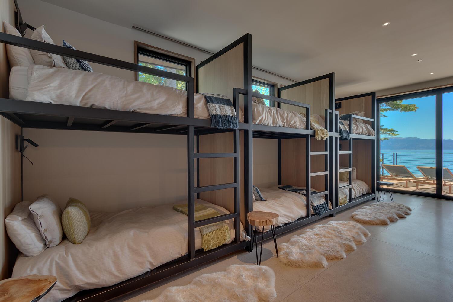 Interior of bunk-style bedroom with lake view.