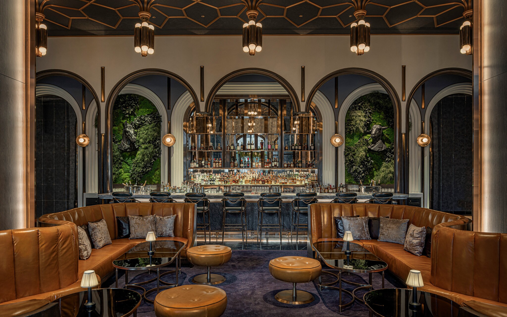 The BKK Social Club has brown leather booths and ottomans, and a line of Art Deco arches behind the bar showcases shelves of liquor.