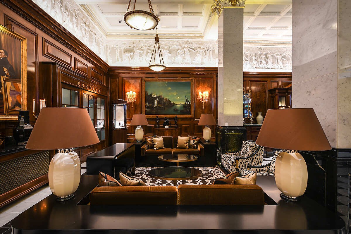 Sitting space with velvet and sconces 