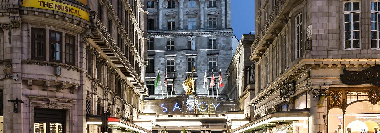 The Savoy entrance at night with flags