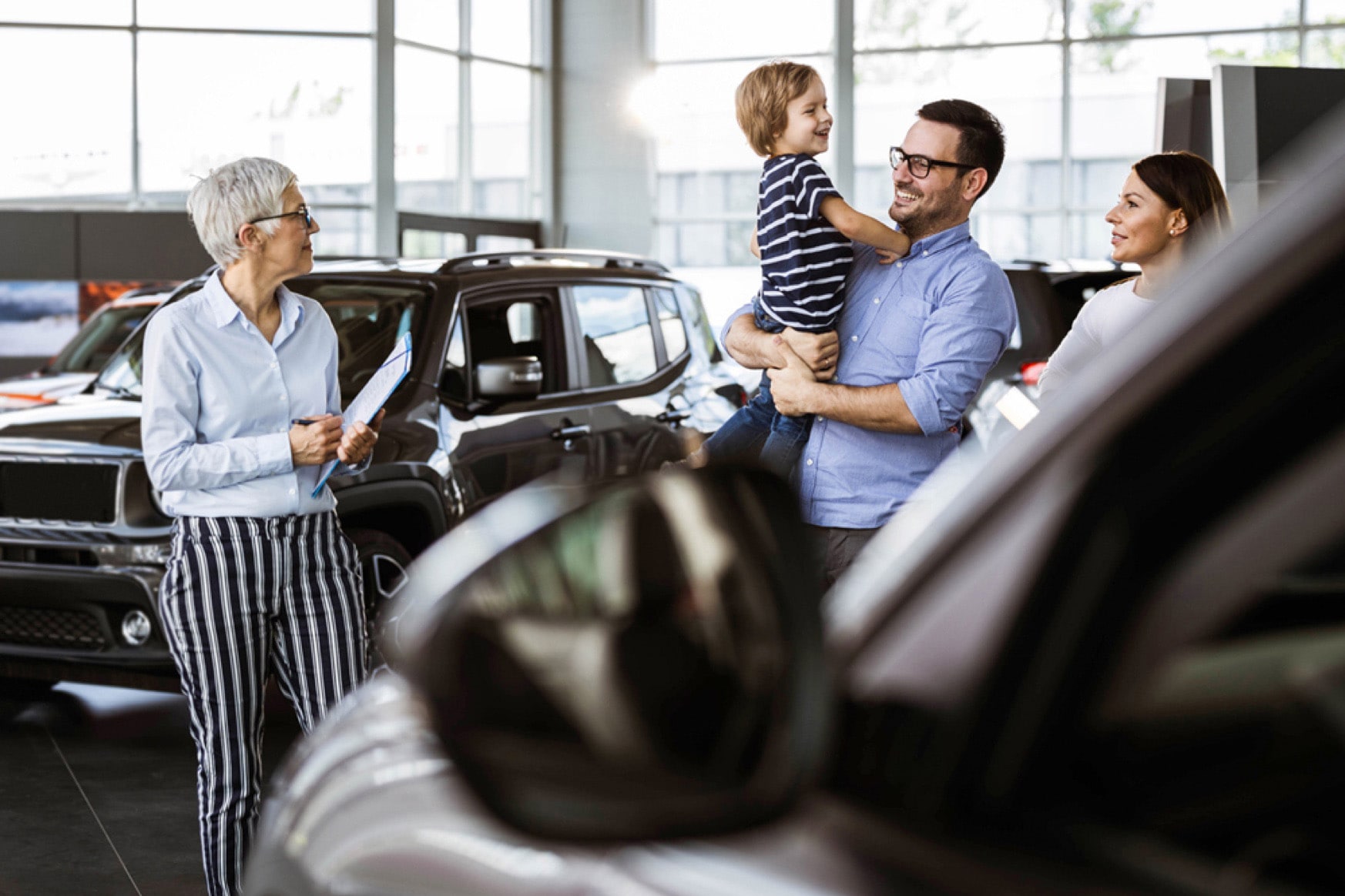 A family purchases a car from a dealer A family purchases a car from a dealer